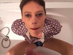 Short hair mature takes facial in the bathtub